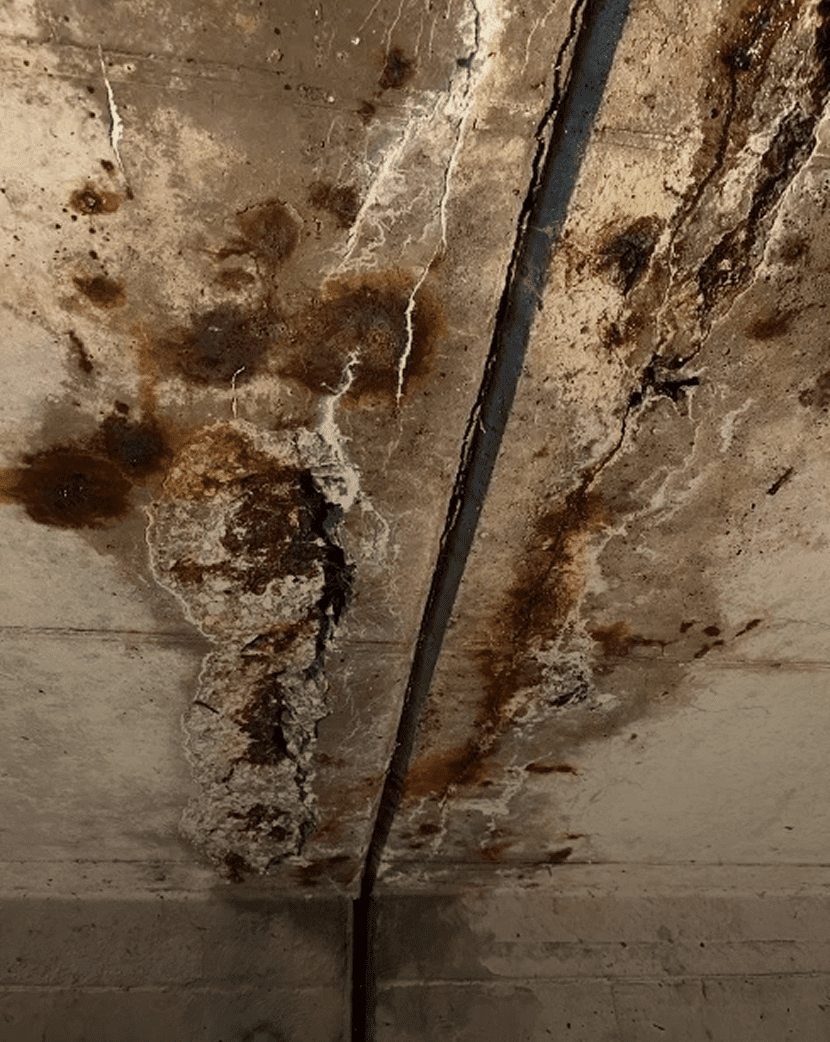 Damaged concrete ceiling with rust stains