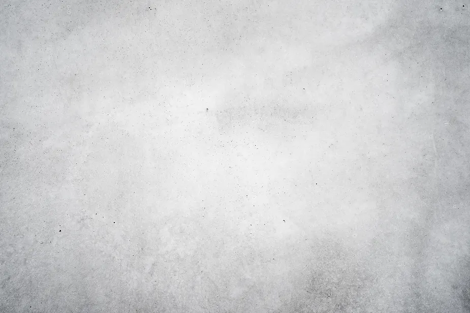 A textured grey concrete wall with subtle variations.