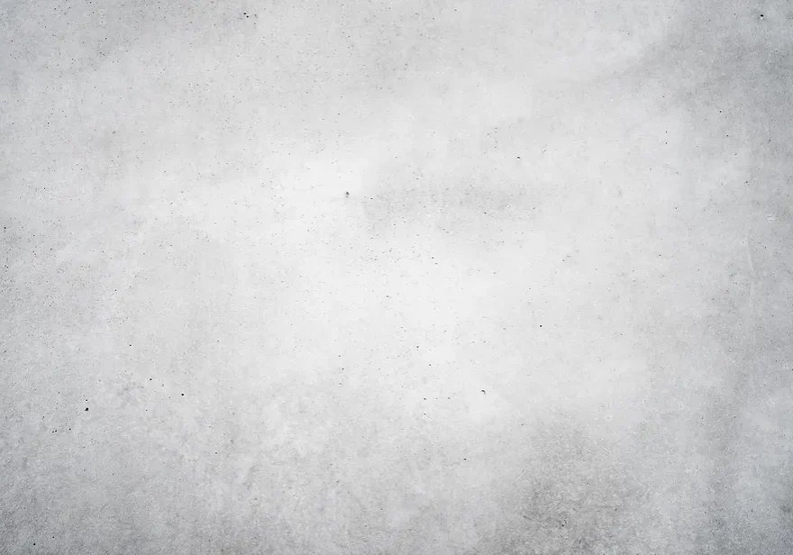 A textured grey concrete wall with subtle variations.