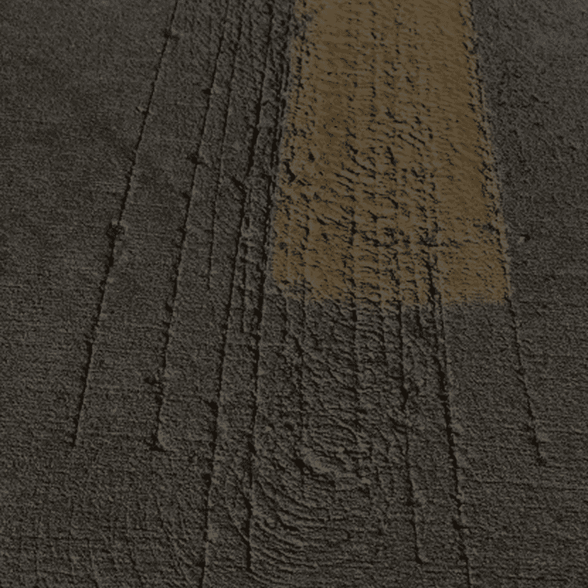 Textured asphalt with yellow stripe